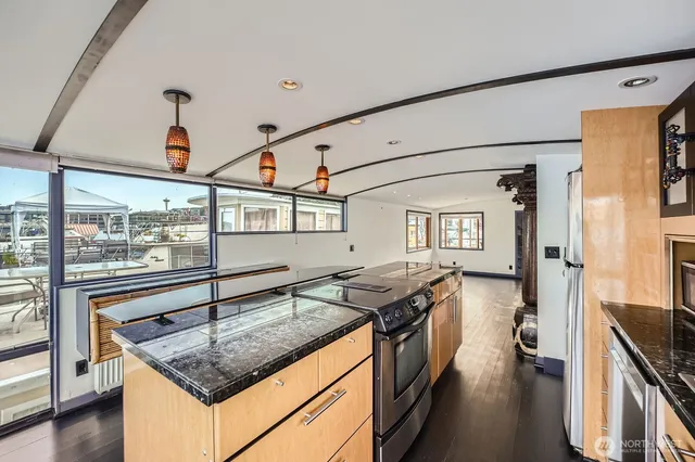 a kitchen with sink refrigerator and stove