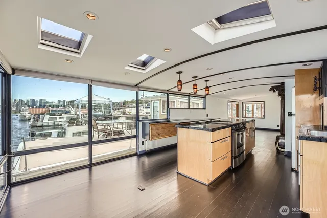 a view of a kitchen with a sink and large window