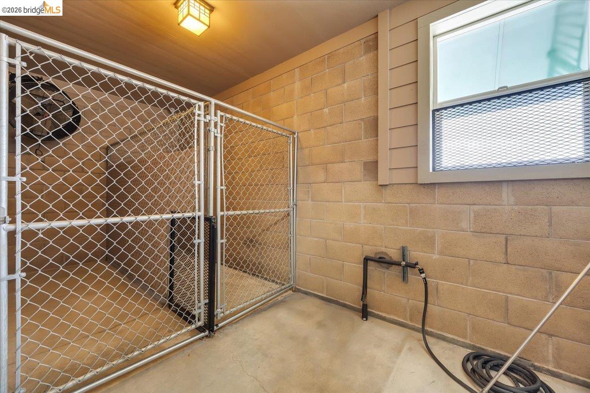 18180 Robin Ridge Road Sonora, CA 95370 - Photo 45 of 88 Enclosed outdoor area featuring a concrete floor, concrete block walls, and a window with security screening