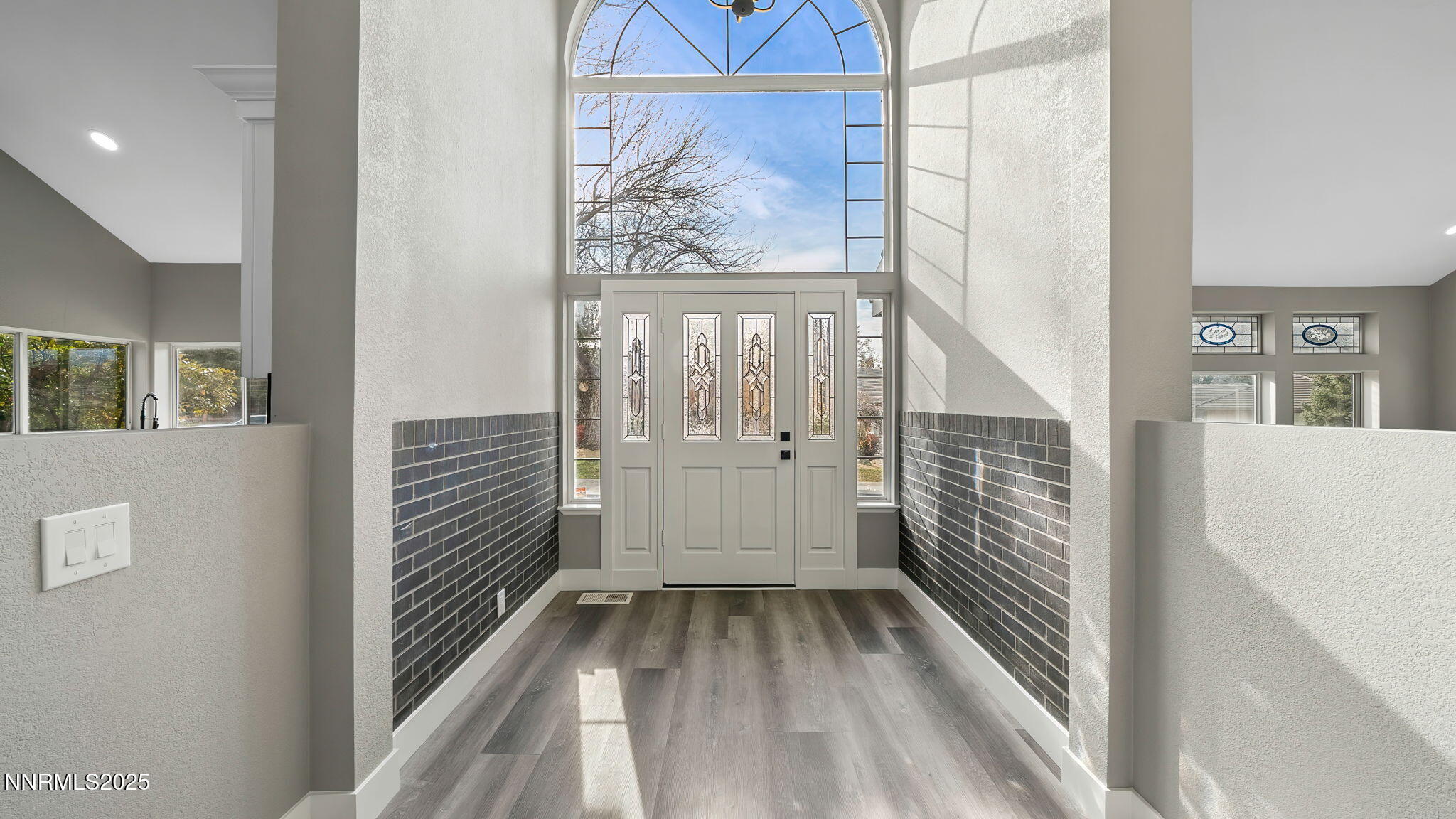 5700 East Hidden Valley Drive Reno, NV 89502 - Photo 17 of 91 a view of a hallway with wooden floor and a bathroom