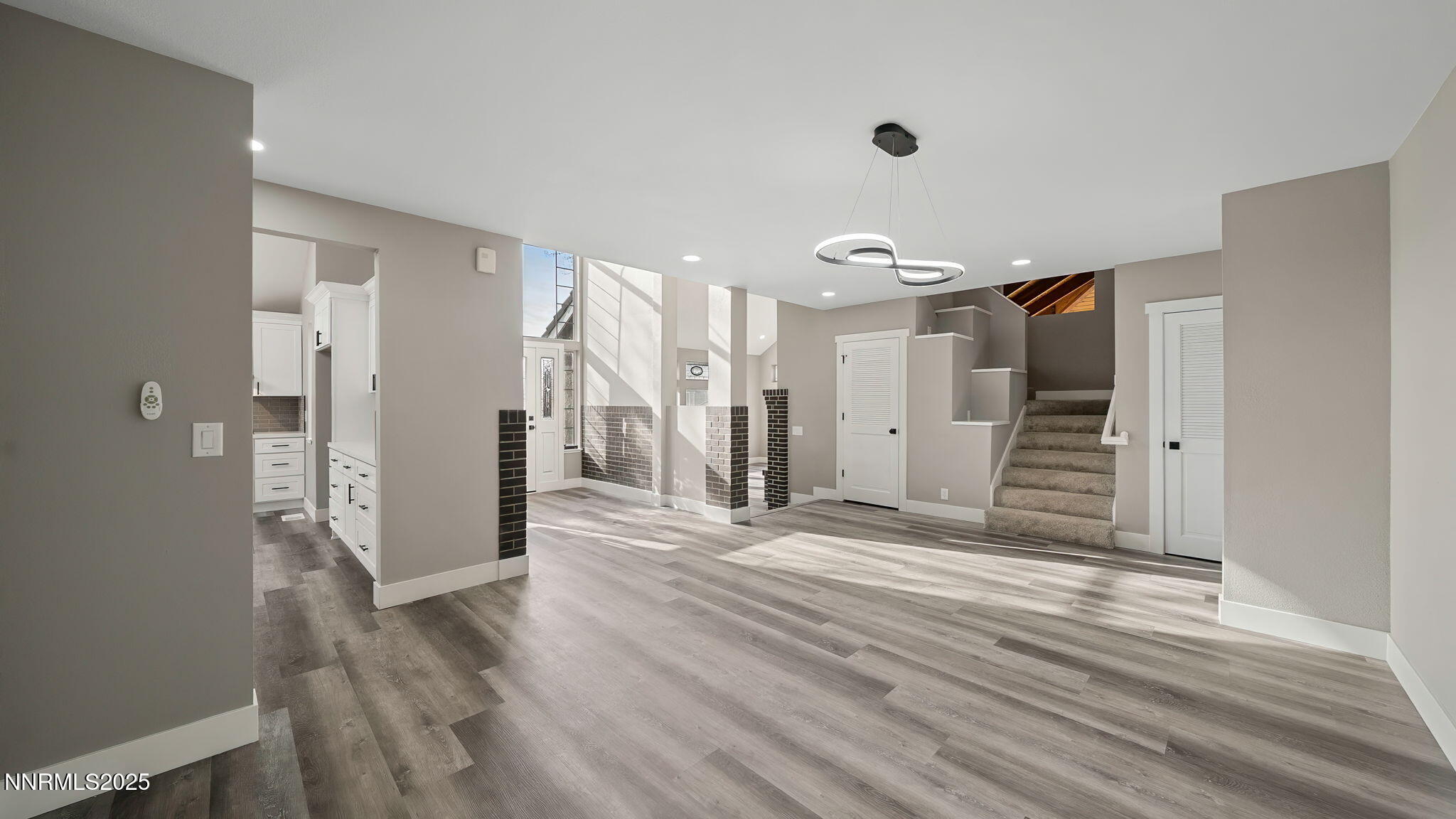 5700 East Hidden Valley Drive Reno, NV 89502 - Photo 24 of 91 a view of a hallway with wooden floor and a ceiling fan