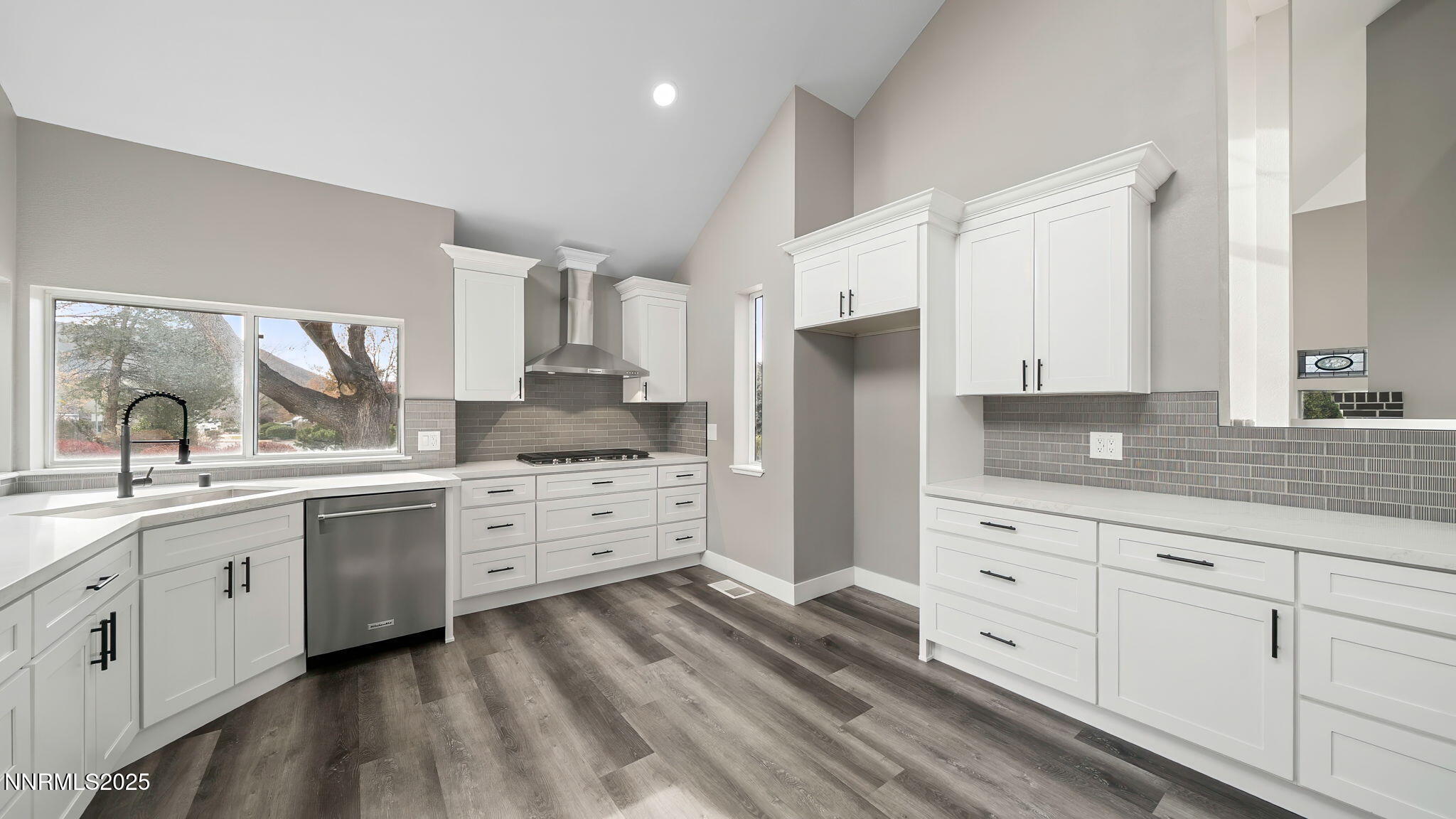 5700 East Hidden Valley Drive Reno, NV 89502 - Photo 32 of 91 a kitchen with white cabinets and stainless steel appliances