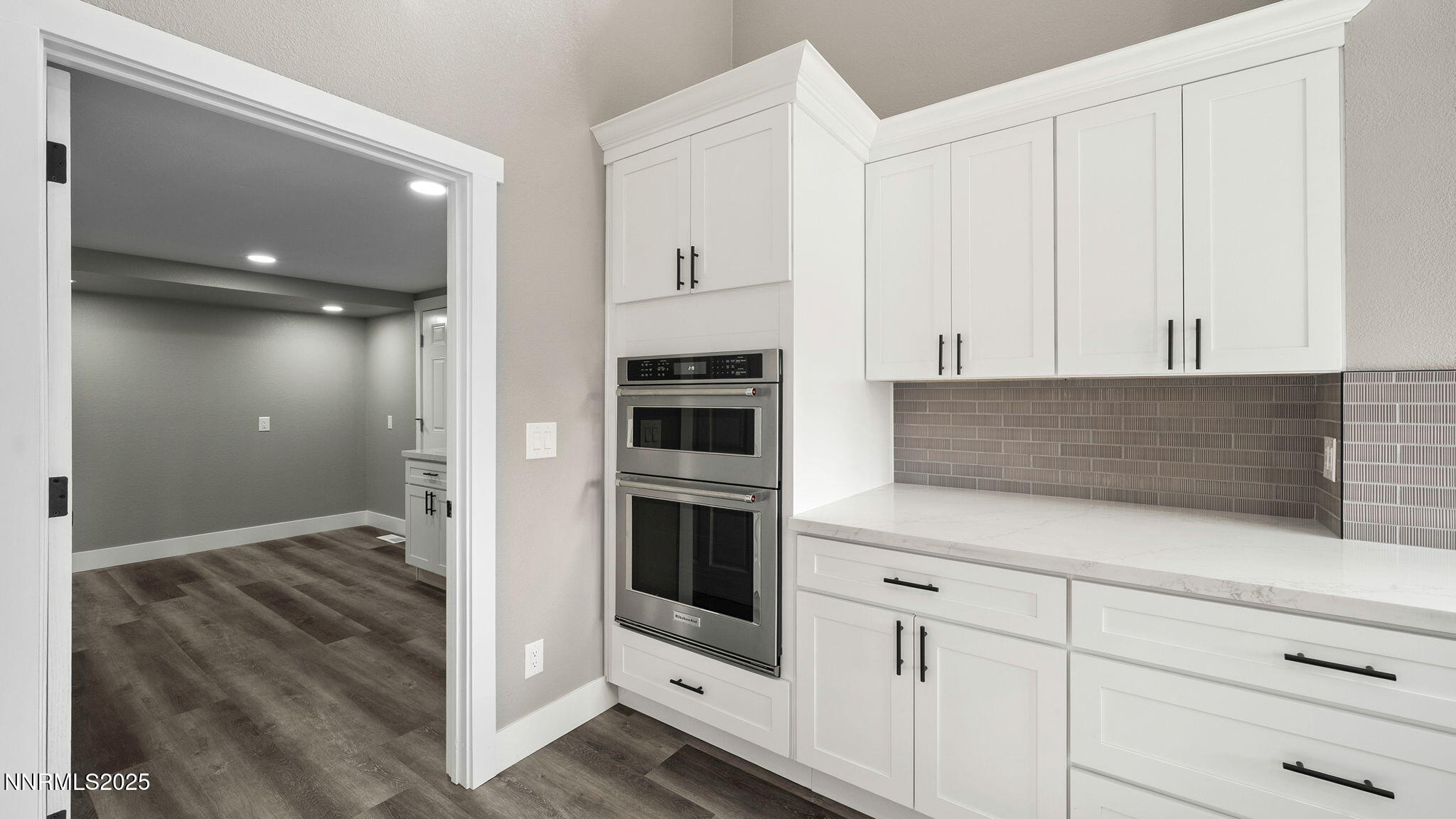5700 East Hidden Valley Drive Reno, NV 89502 - Photo 34 of 91 a kitchen with white cabinets and white appliances