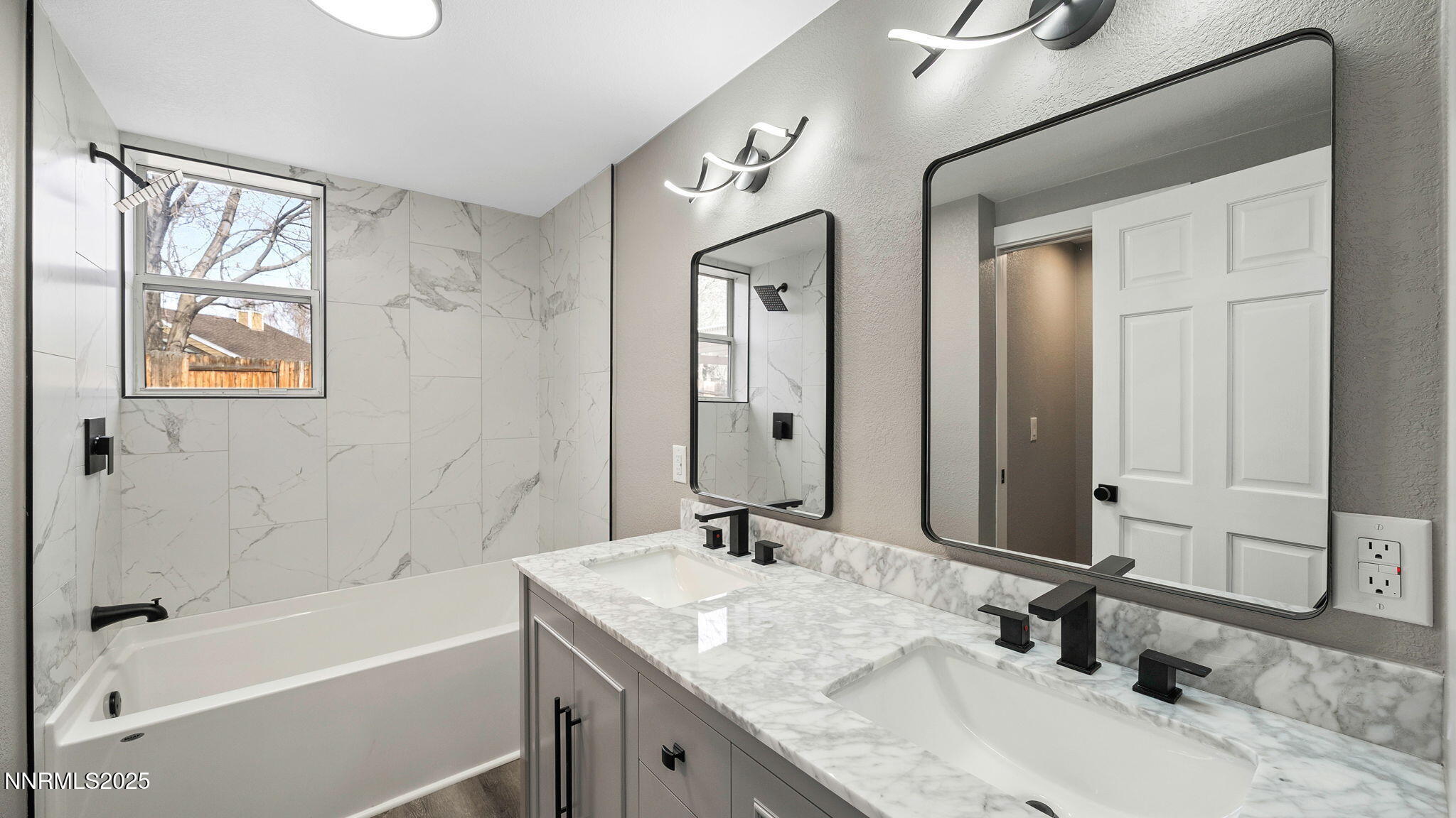 5700 East Hidden Valley Drive Reno, NV 89502 - Photo 47 of 91 a bathroom with a granite countertop sink a mirror a bathtub and shower