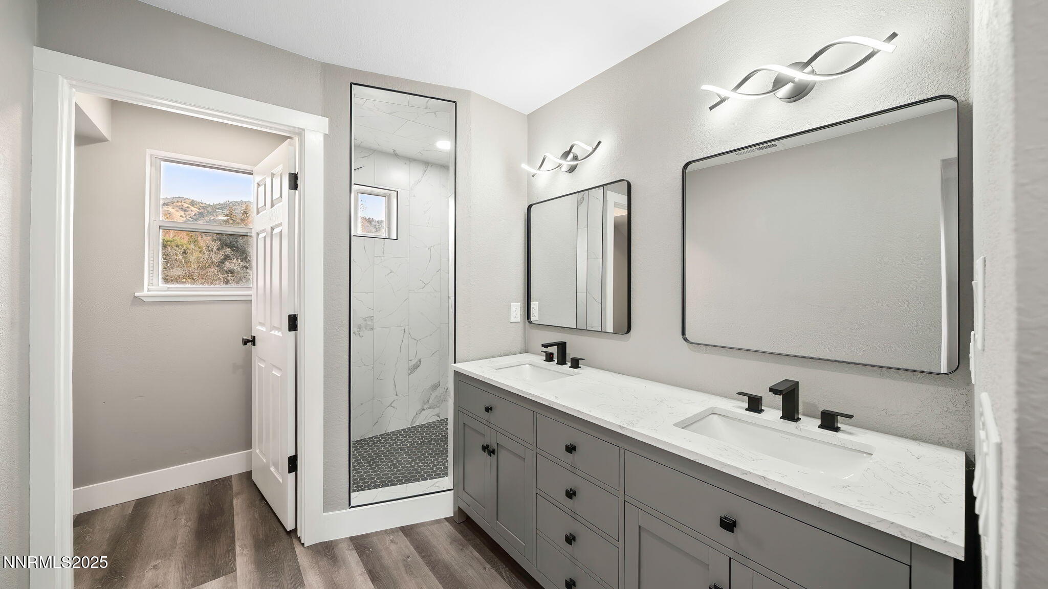 5700 East Hidden Valley Drive Reno, NV 89502 - Photo 57 of 91 a bathroom with a double vanity sink mirror and shower