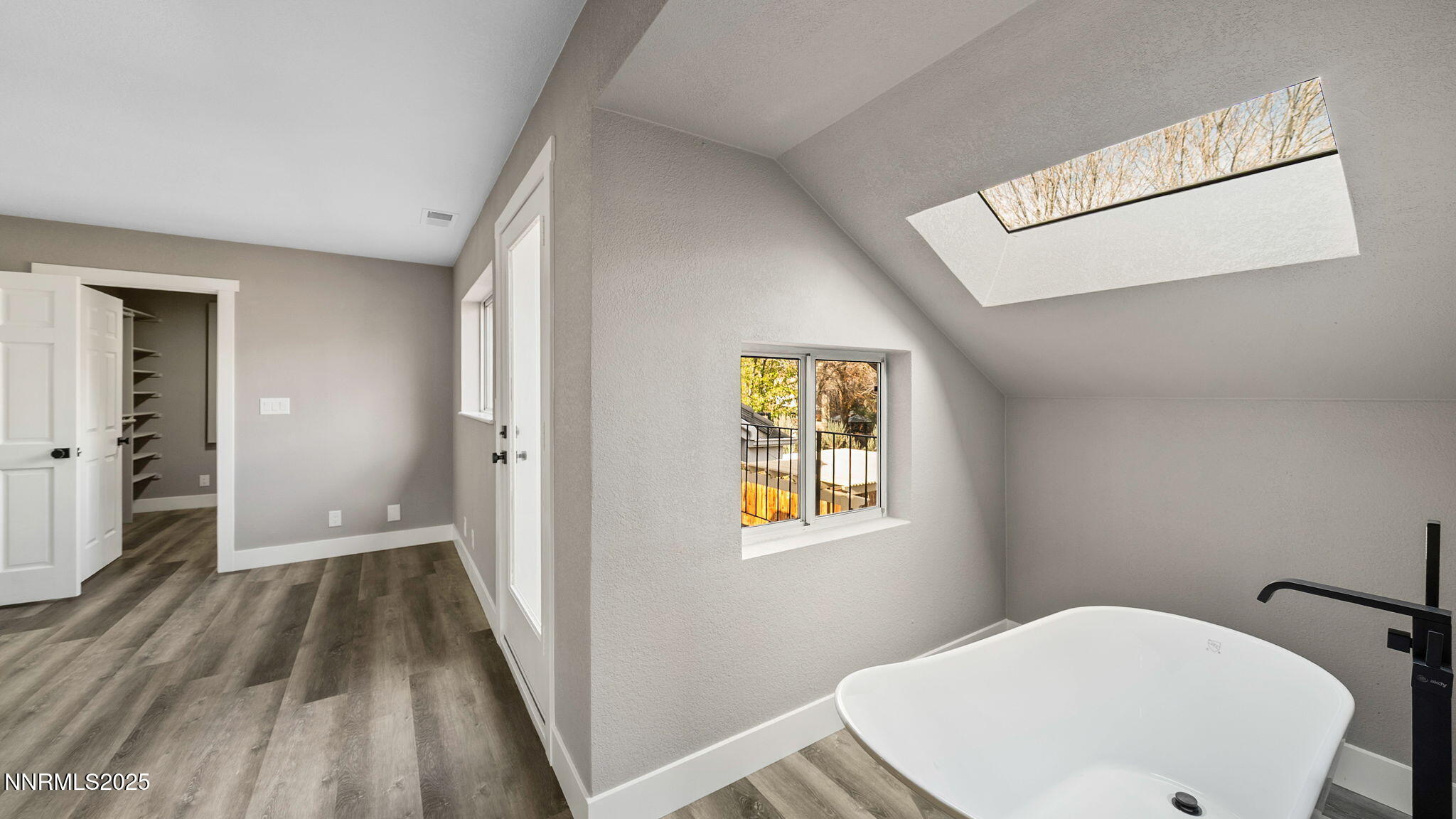 5700 East Hidden Valley Drive Reno, NV 89502 - Photo 61 of 91 a view of a hallway with wooden floor and a bathroom