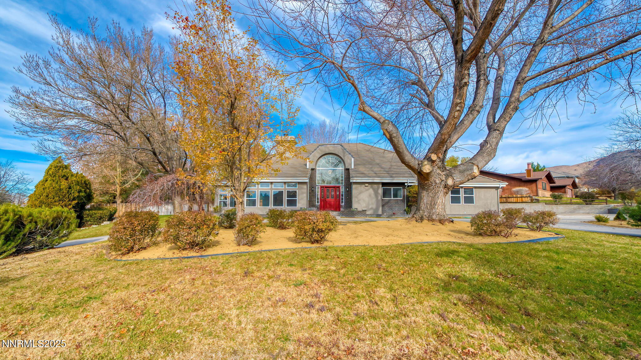 5700 East Hidden Valley Drive Reno, NV 89502 - Photo 90 of 91 a front view of a house with a yard covered with snow