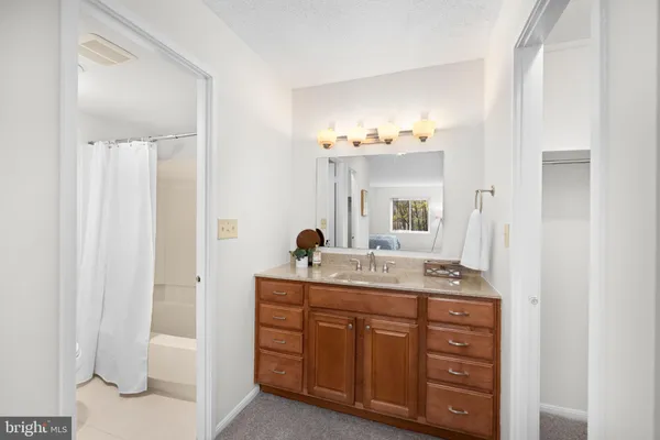 a room with a mirror and a bathroom