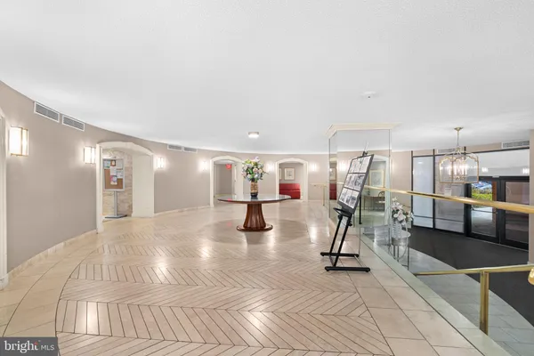 a view of an entryway with table and hallway