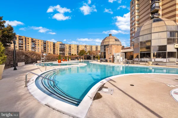 a street sign on a wall next to a road