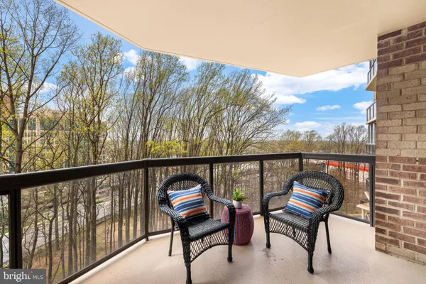a view of a two chairs in the balcony