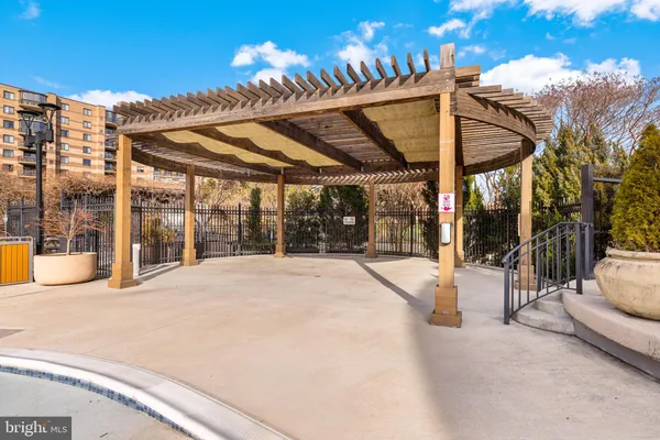 a view of a swimming pool with a dining table and chairs