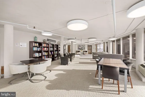 a lobby with furniture and large windows