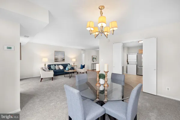a view of a dining room with furniture and chandelier