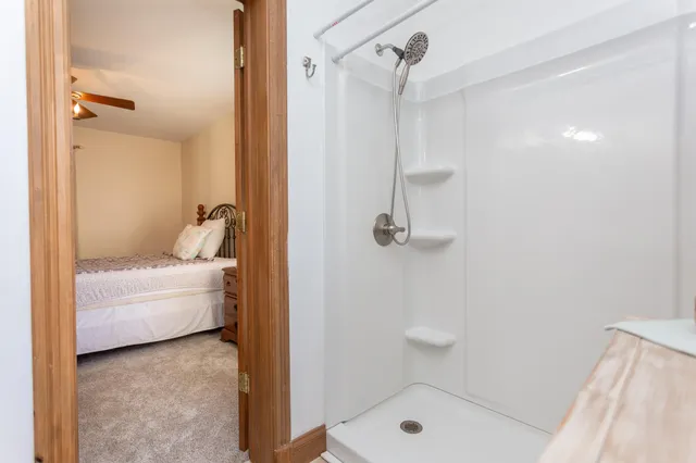 a bathroom with a tub a toilet and a shower