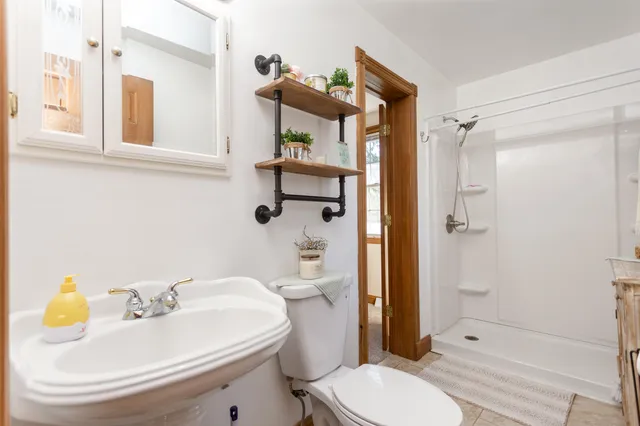 a bathroom with a sink toilet and shower