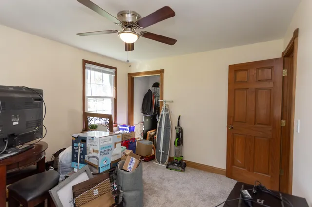 a view of a workspace with furniture and a window