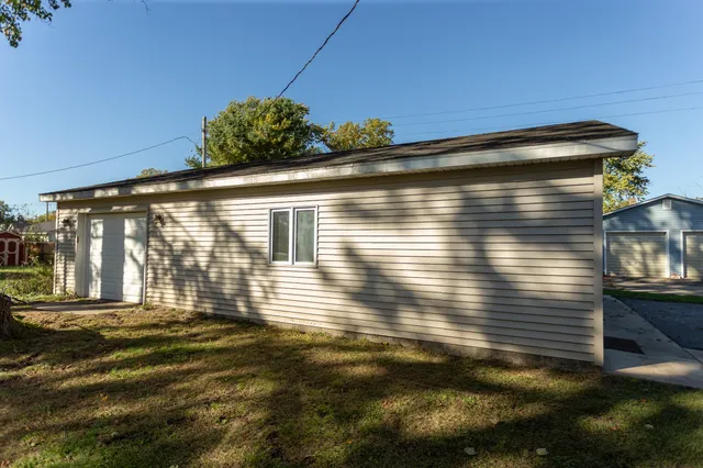 a view of backyard with wooden fence