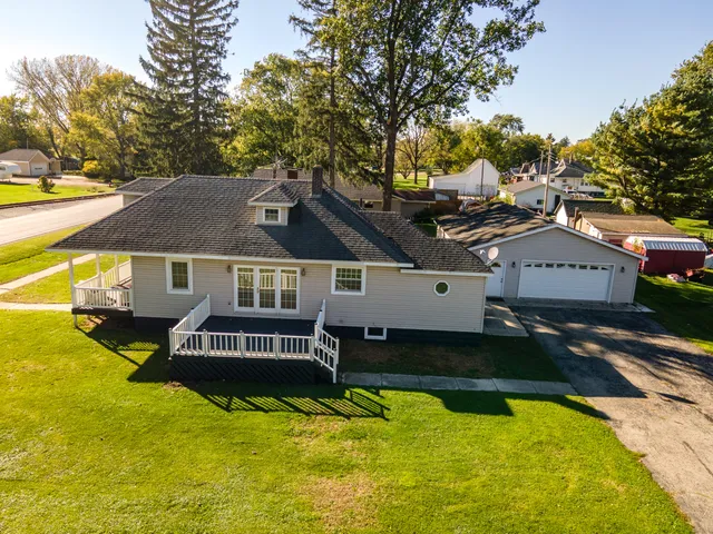 a view of a house with pool and sitting area