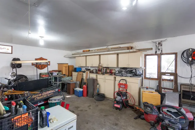 a storage room with lots of clutter and bicycles
