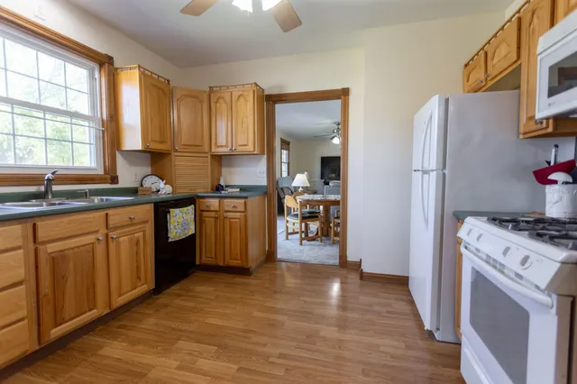 a kitchen with stainless steel appliances granite countertop a stove a sink dishwasher and a refrigerator