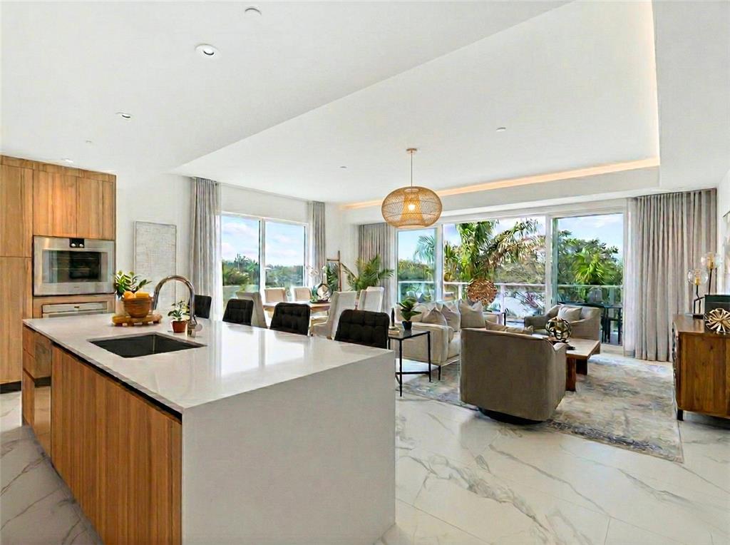 a kitchen with counter top space and living room