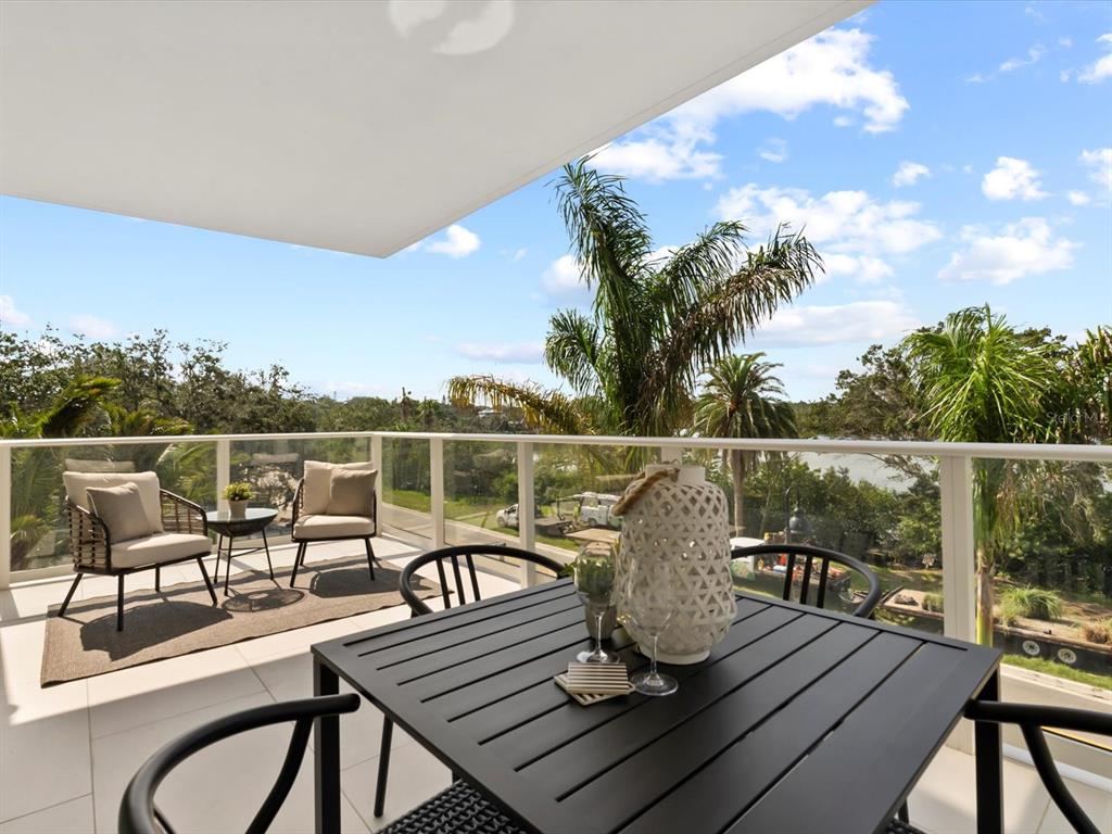 1020 Sunset Point Road, Unit 213 Clearwater, FL 33755 - Photo 20 of 42 a view of a chairs and table on the deck