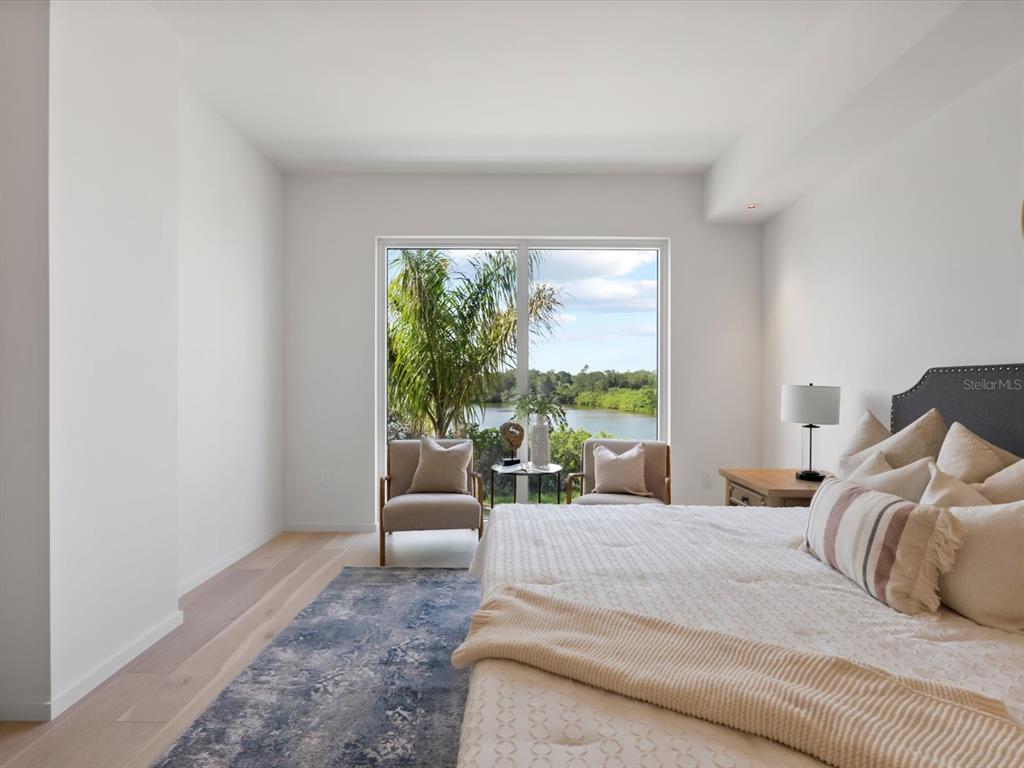 1020 Sunset Point Road, Unit 213 Clearwater, FL 33755 - Photo 23 of 42 a bedroom with a bed and a large window