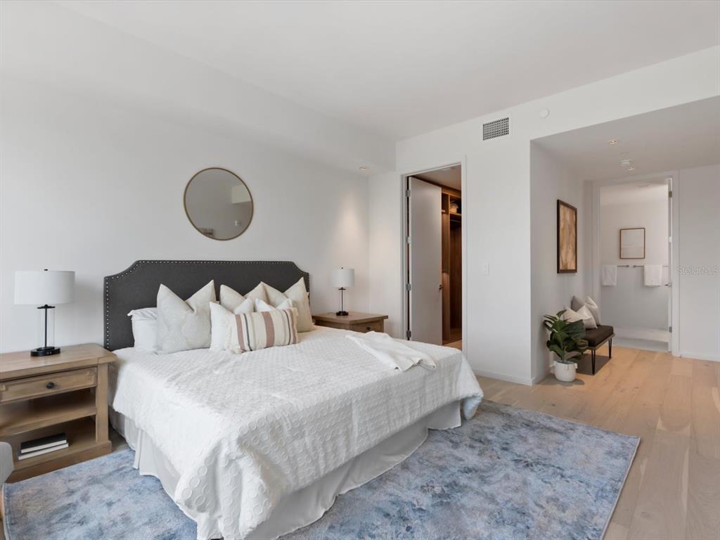 1020 Sunset Point Road, Unit 213 Clearwater, FL 33755 - Photo 26 of 42 a bedroom with bed and wooden floor