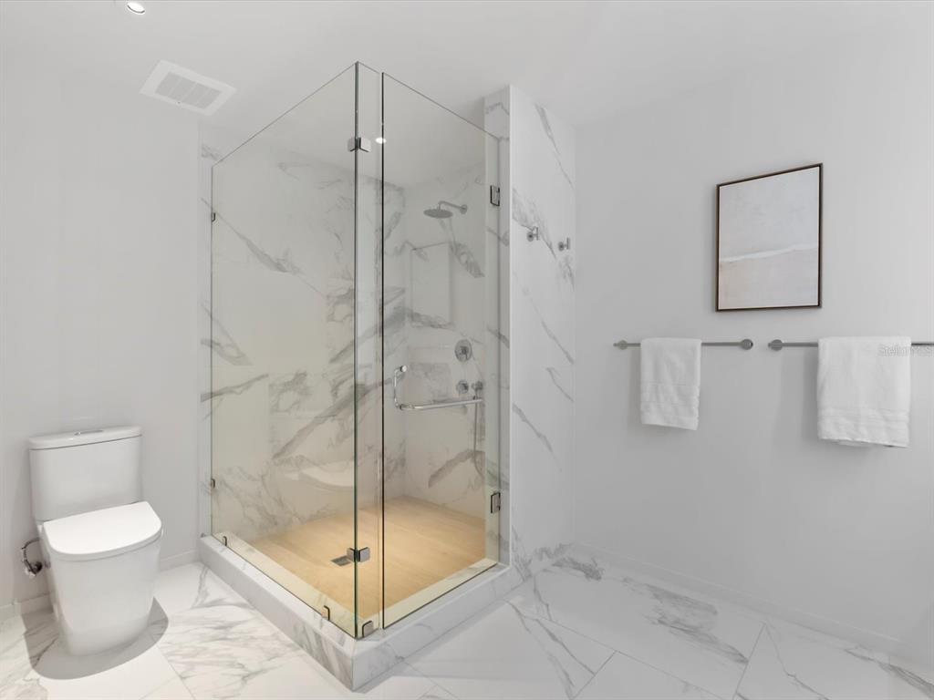 1020 Sunset Point Road, Unit 213 Clearwater, FL 33755 - Photo 30 of 42 a bathroom with a shower and toilet