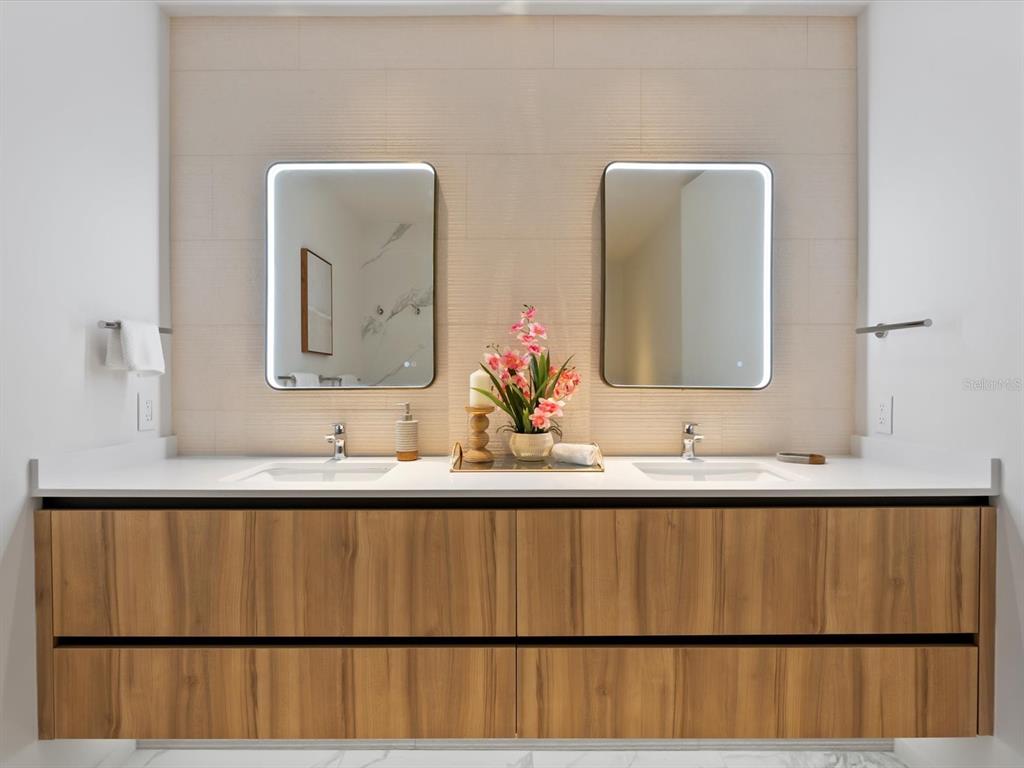 1020 Sunset Point Road, Unit 213 Clearwater, FL 33755 - Photo 31 of 42 a bathroom with a sink and a mirror