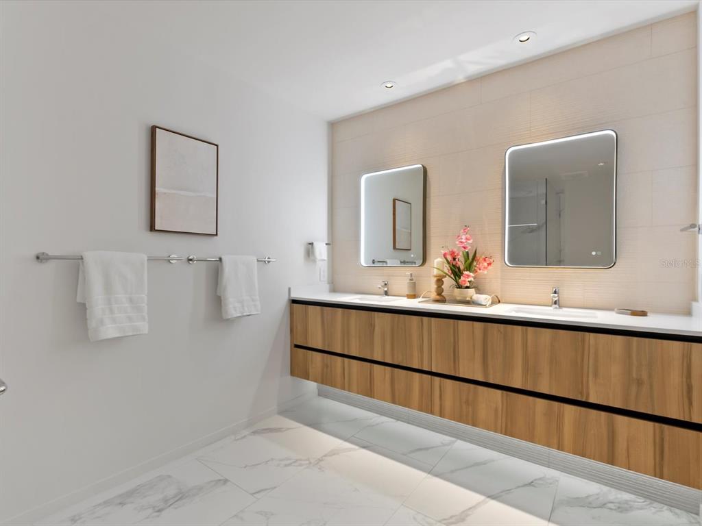 1020 Sunset Point Road, Unit 213 Clearwater, FL 33755 - Photo 32 of 42 a bathroom with a sink and mirror
