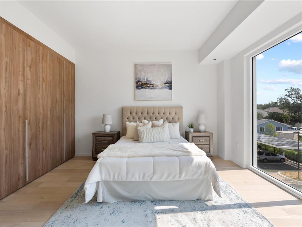 1020 Sunset Point Road, Unit 213 Clearwater, FL 33755 - Photo 33 of 42 a bedroom with a bed and a painting on the wall