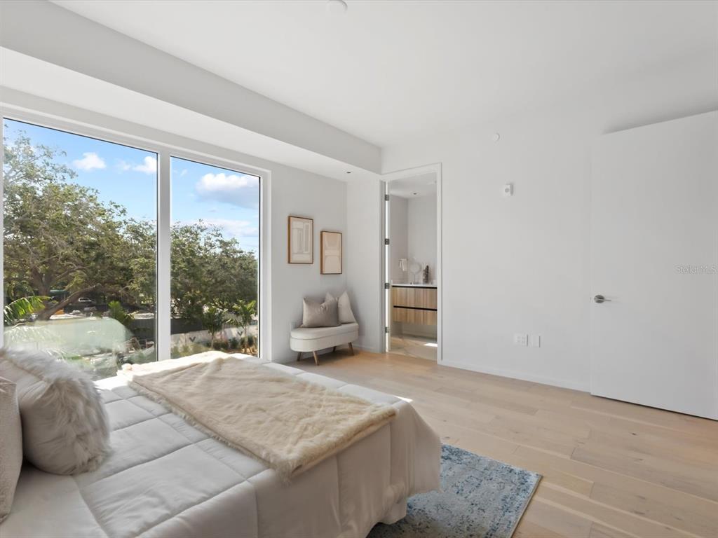 1020 Sunset Point Road, Unit 213 Clearwater, FL 33755 - Photo 35 of 42 a bedroom with a large bed and a large window