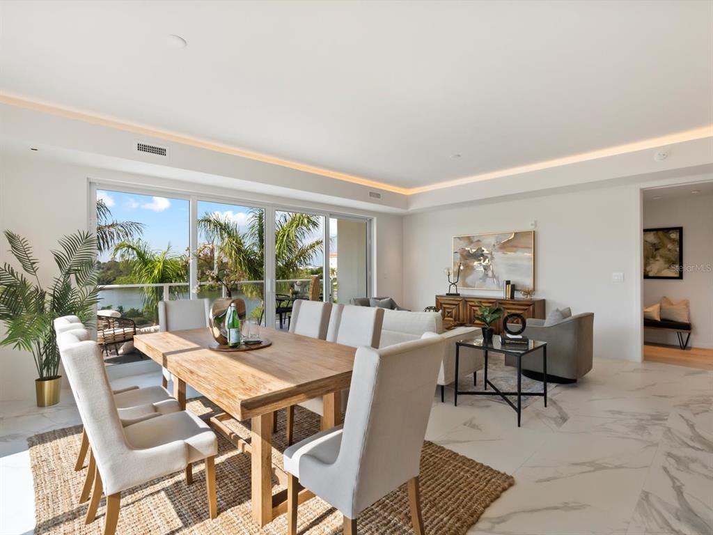 1020 Sunset Point Road, Unit 213 Clearwater, FL 33755 - Photo 7 of 42 a dining room with furniture and a floor to ceiling window