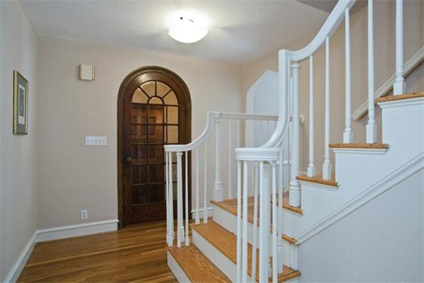 25 Lancaster Road Newton, MA 02458 - Photo 2 of 10 a view of a hallway with wooden floor and entryway