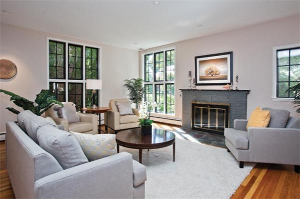 25 Lancaster Road Newton, MA 02458 - Photo 4 of 10 a living room with furniture a large window and a fireplace