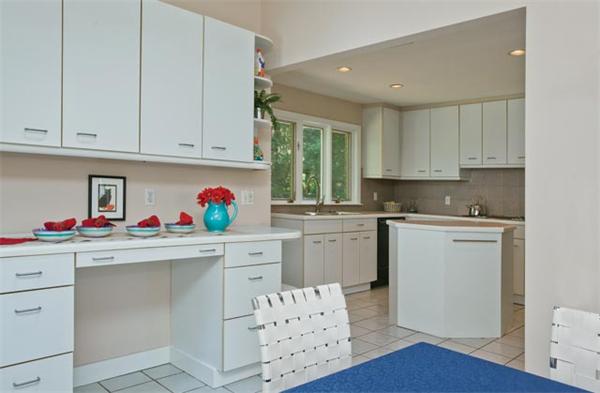 25 Lancaster Road Newton, MA 02458 - Photo 7 of 10 a kitchen with white cabinets sink and window