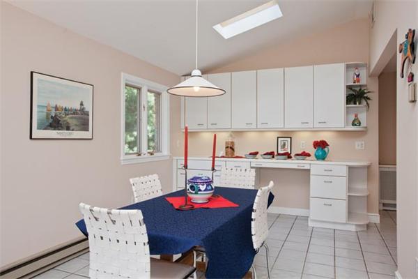 25 Lancaster Road Newton, MA 02458 - Photo 8 of 10 a open dining room with stainless steel appliances a table and chairs