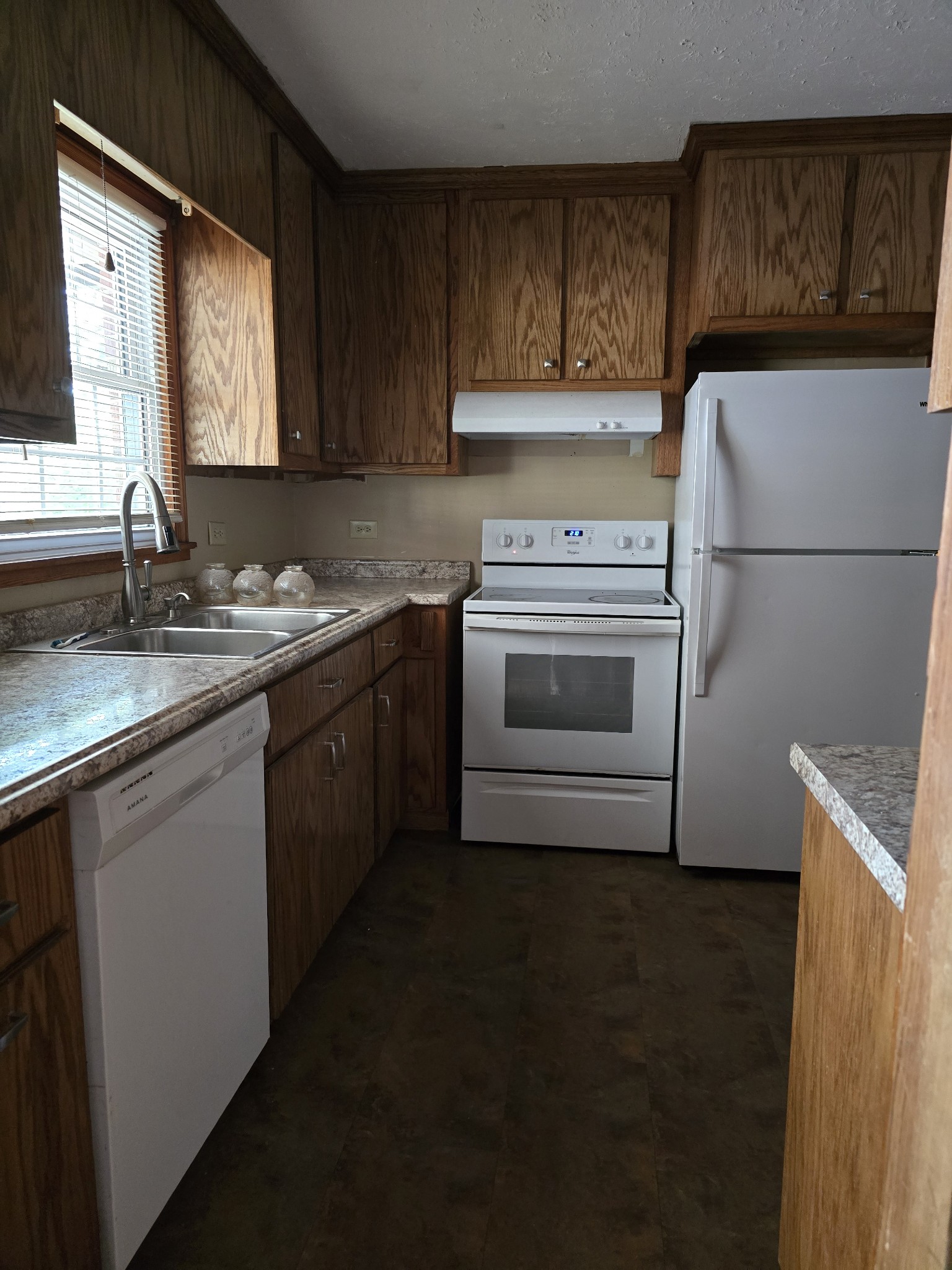 705 Nichols Street Pulaski, TN 38478 - Photo 4 of 7 a kitchen with a sink and a refrigerator