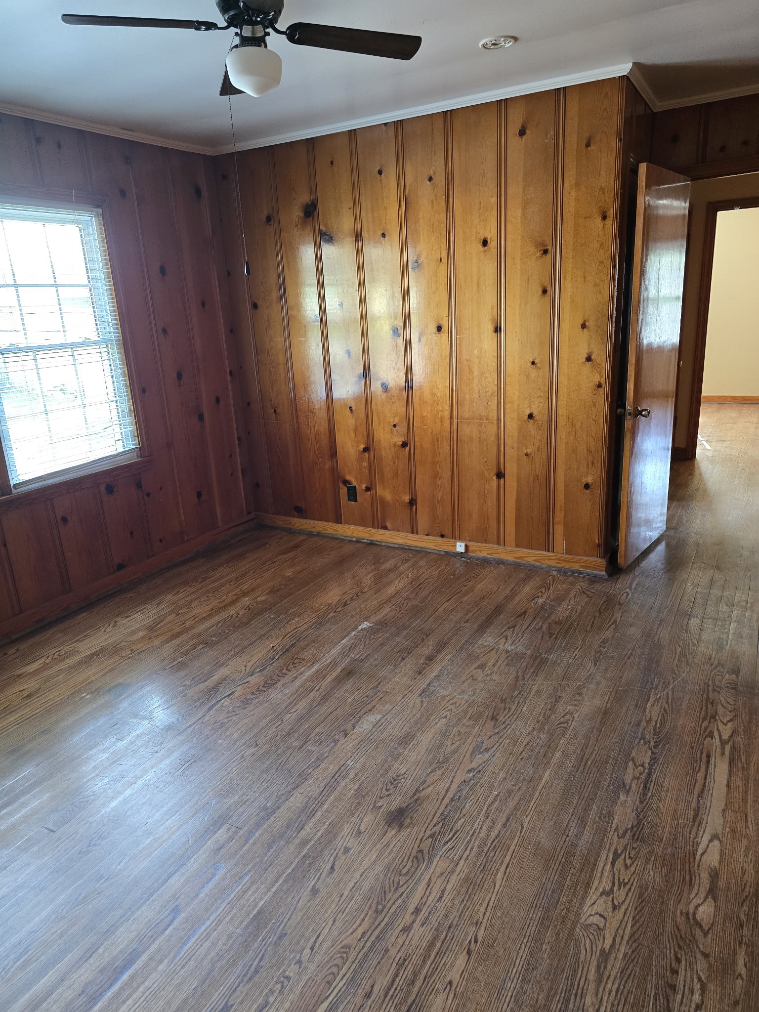 705 Nichols Street Pulaski, TN 38478 - Photo 5 of 7 an empty room with wooden floor and windows