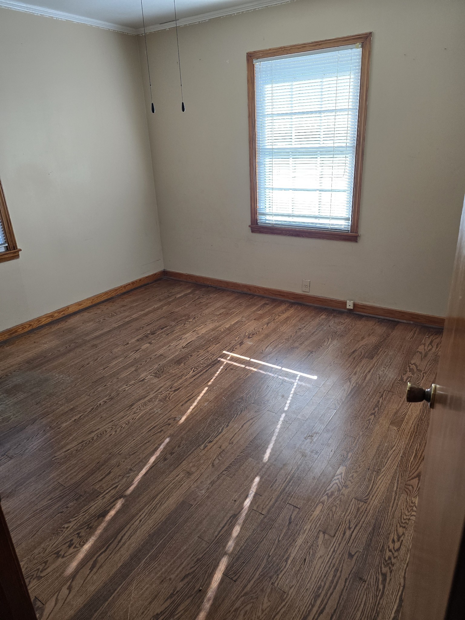 705 Nichols Street Pulaski, TN 38478 - Photo 7 of 7 an empty room with wooden floor and windows