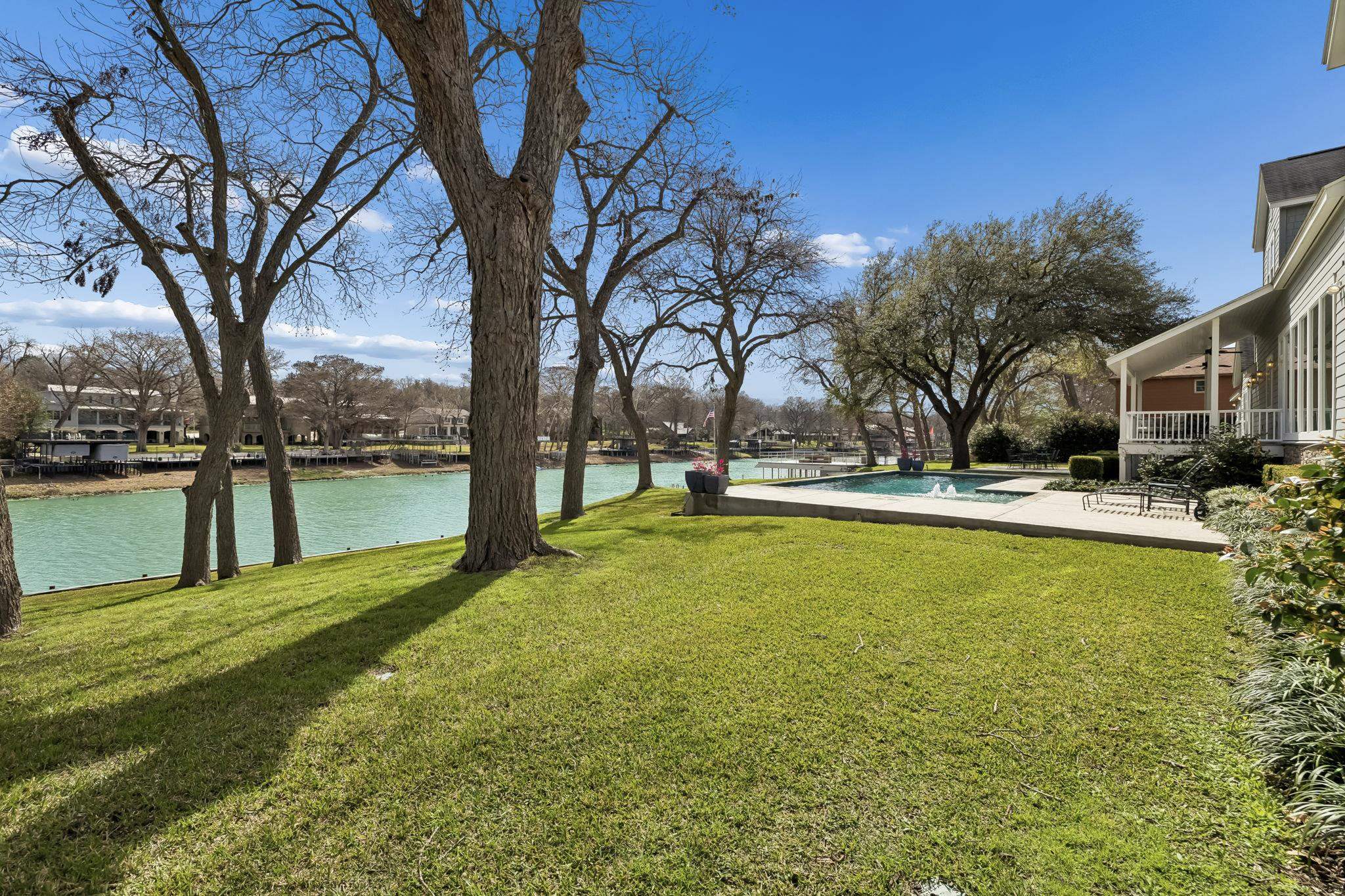 a view of swimming pool with outdoor seating and lake view