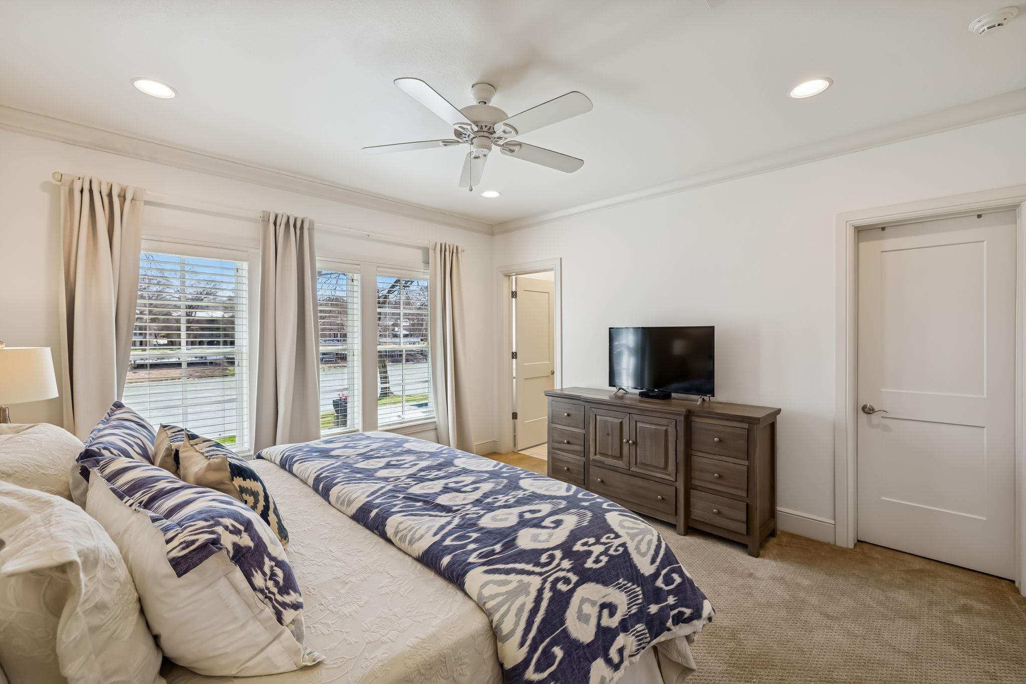 2319 Terminal Loop Road McQueeney, TX 78123 - Photo 15 of 30 a bedroom with a large bed and a flat tv screen