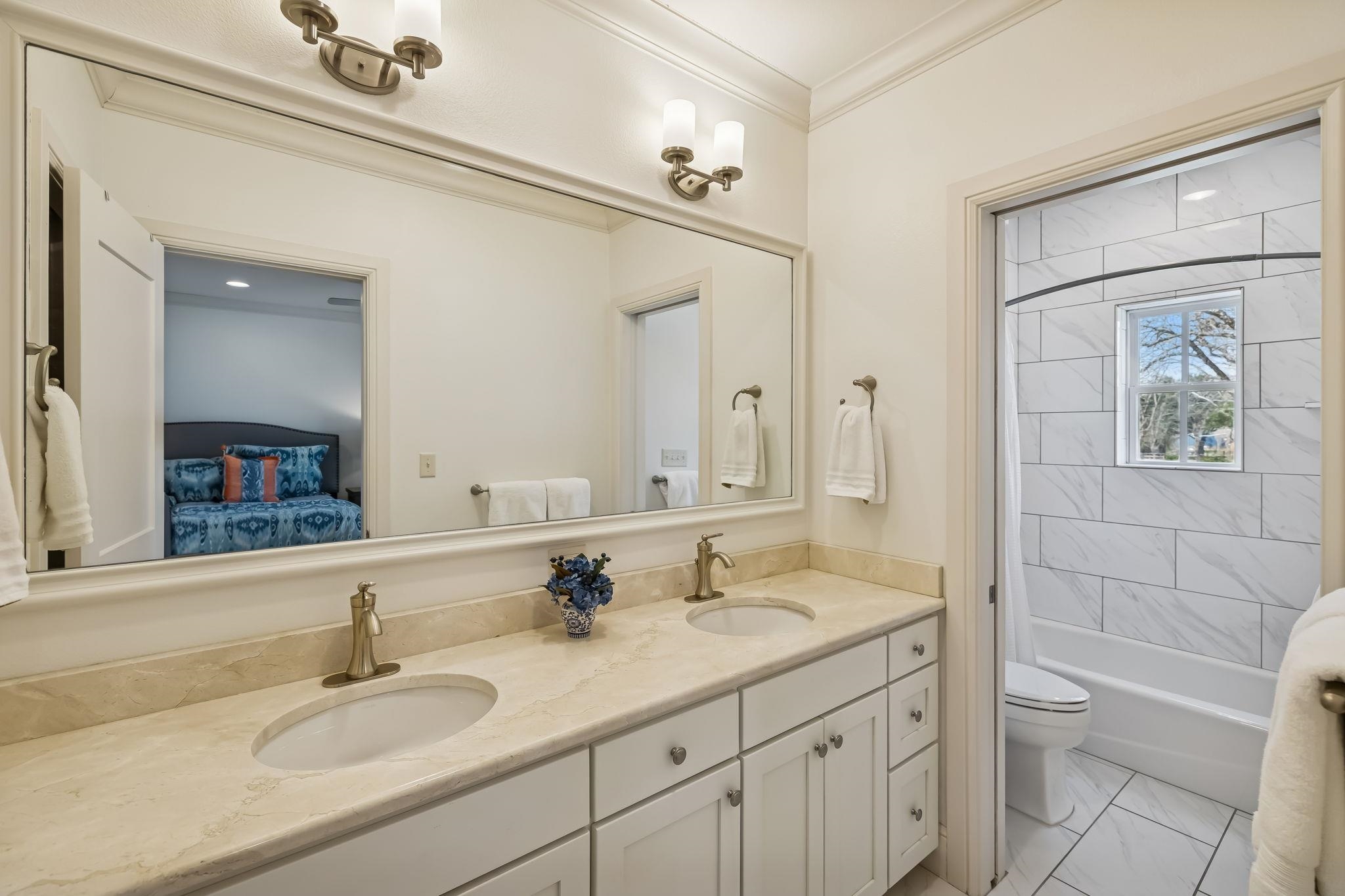 2319 Terminal Loop Road McQueeney, TX 78123 - Photo 18 of 30 a bathroom with a granite countertop sink a toilet and a mirror
