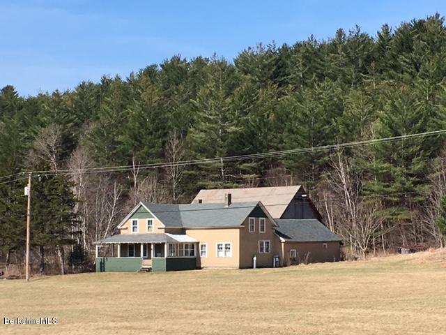 2581 Main Road Stamford, VT 05352 - Photo 1 of 5 a front view of a house with a wrought fence