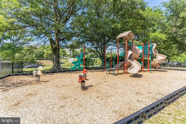 a view of a swimming pool with a bench and fire pit