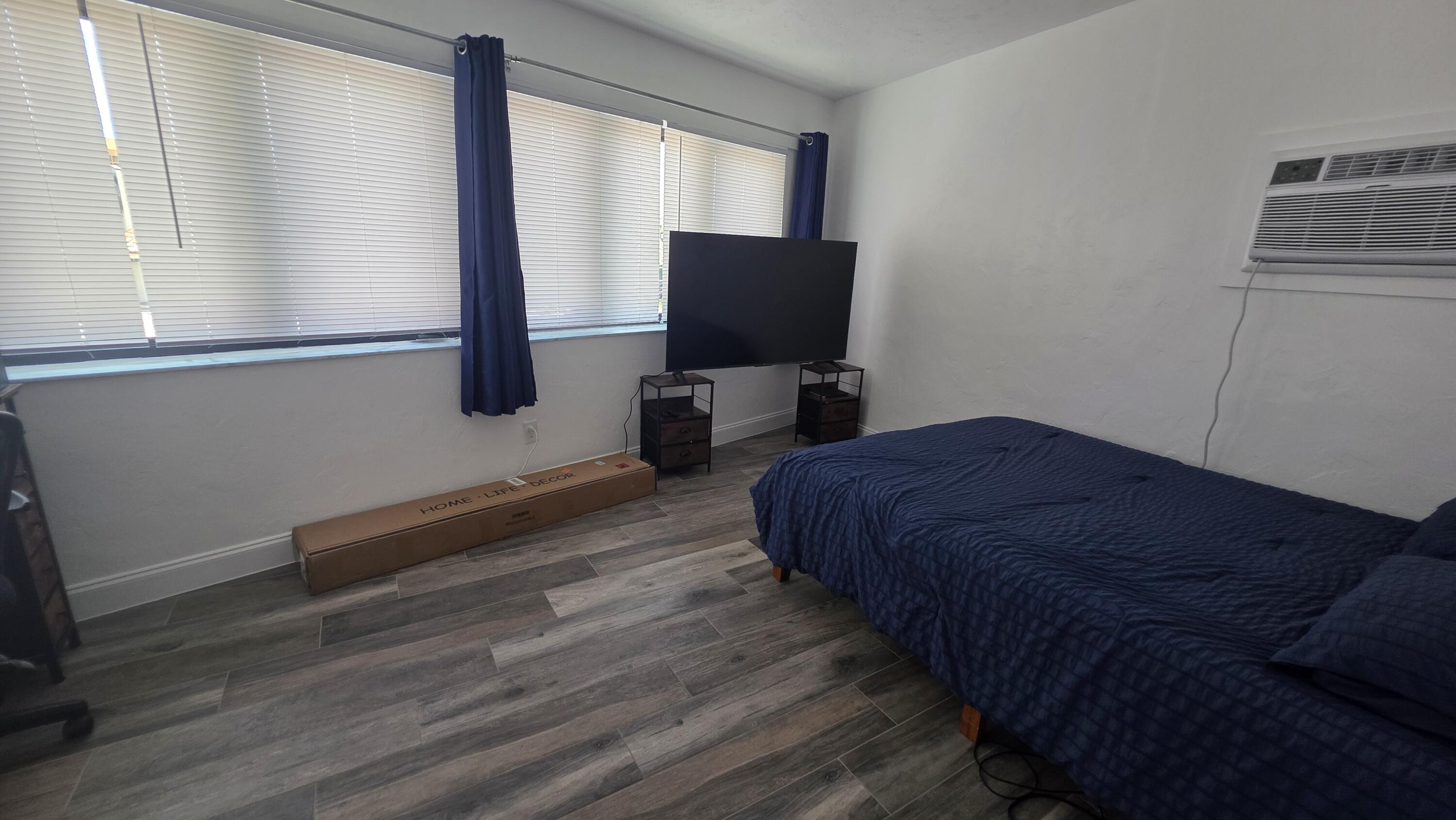 117 North 5th Street Fort Pierce, FL 34950 - Photo 20 of 30 a bedroom with a bed and wooden floor