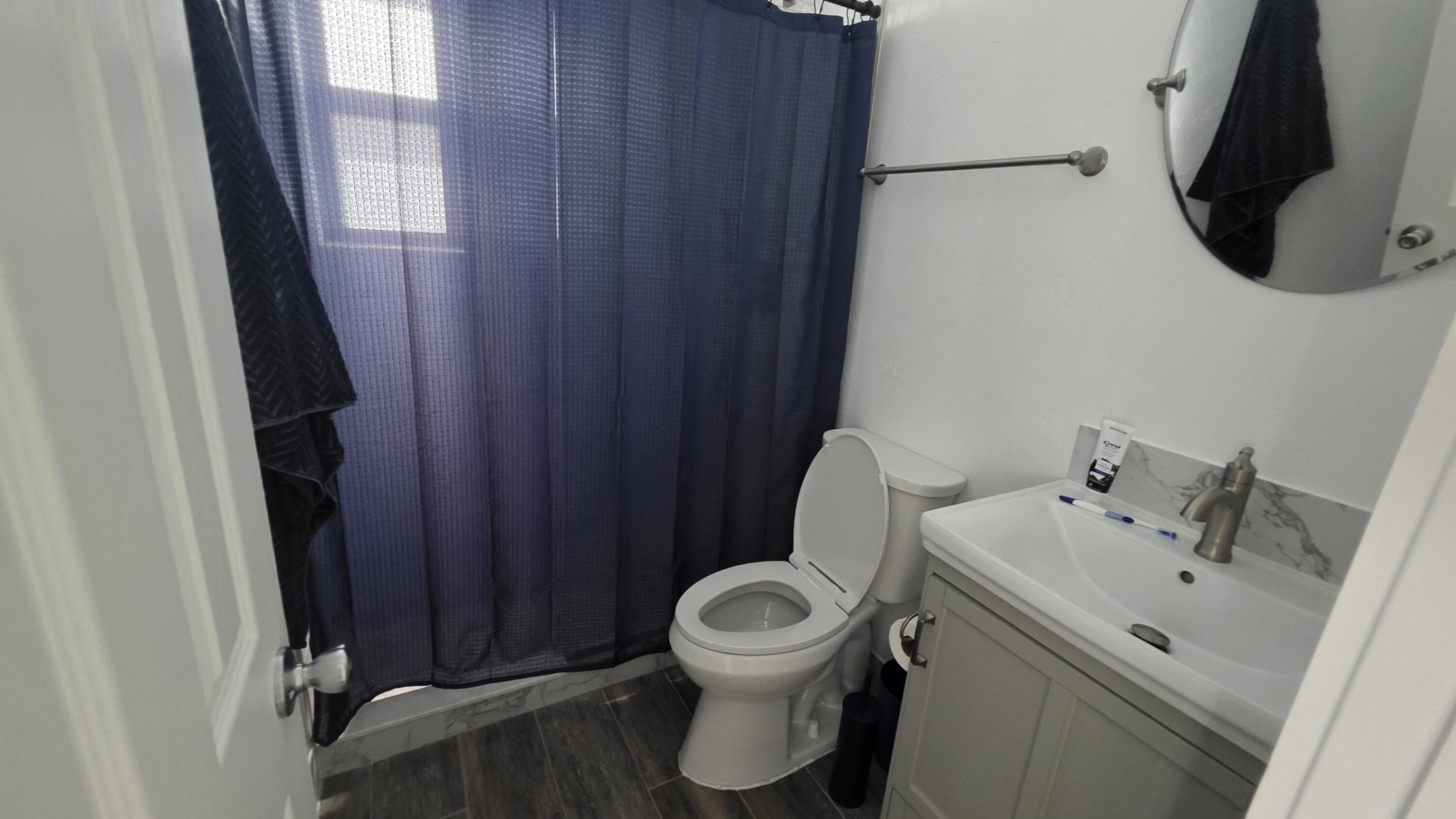 117 North 5th Street Fort Pierce, FL 34950 - Photo 21 of 30 a bathroom with a toilet sink and mirror