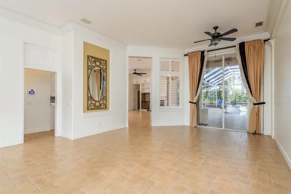 a view of an empty room with a fireplace and a window